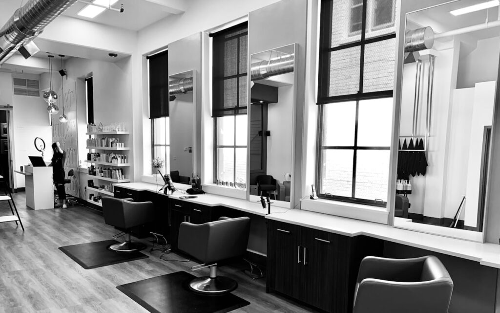 Salon interior with a row of styling chairs and mirrors