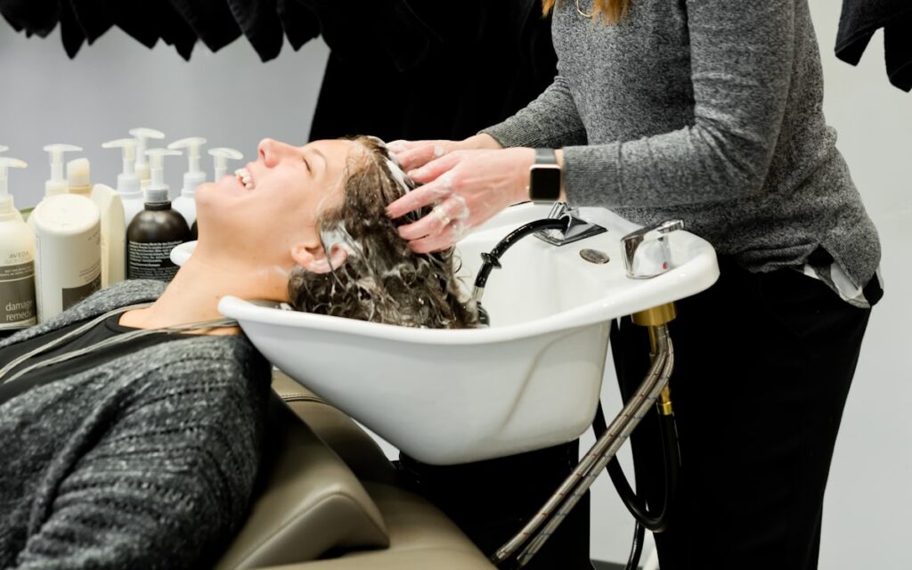 Stylist caring for a client at the salon basin